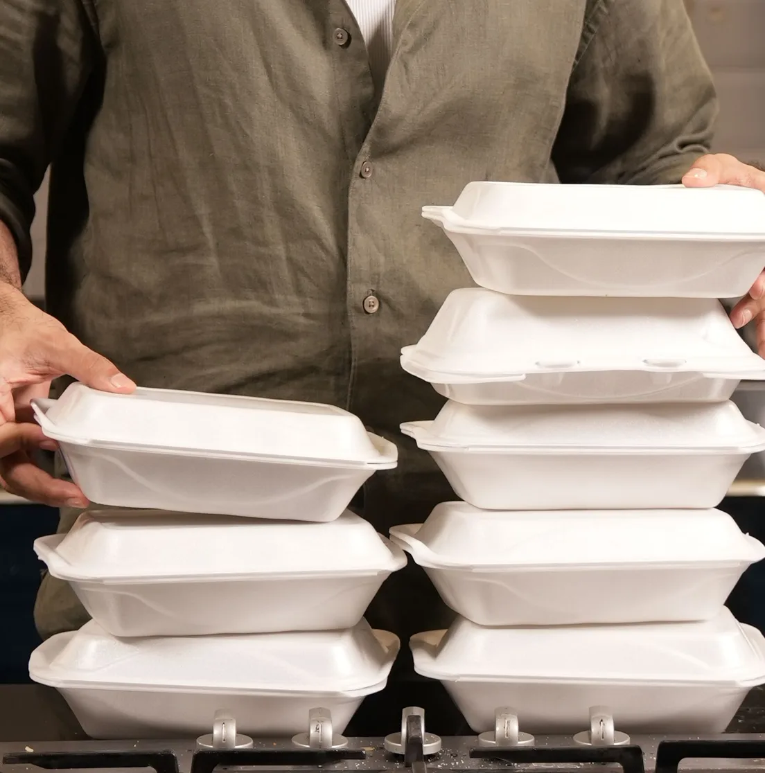 Stacked dawat meal boxes collected on the stovetop